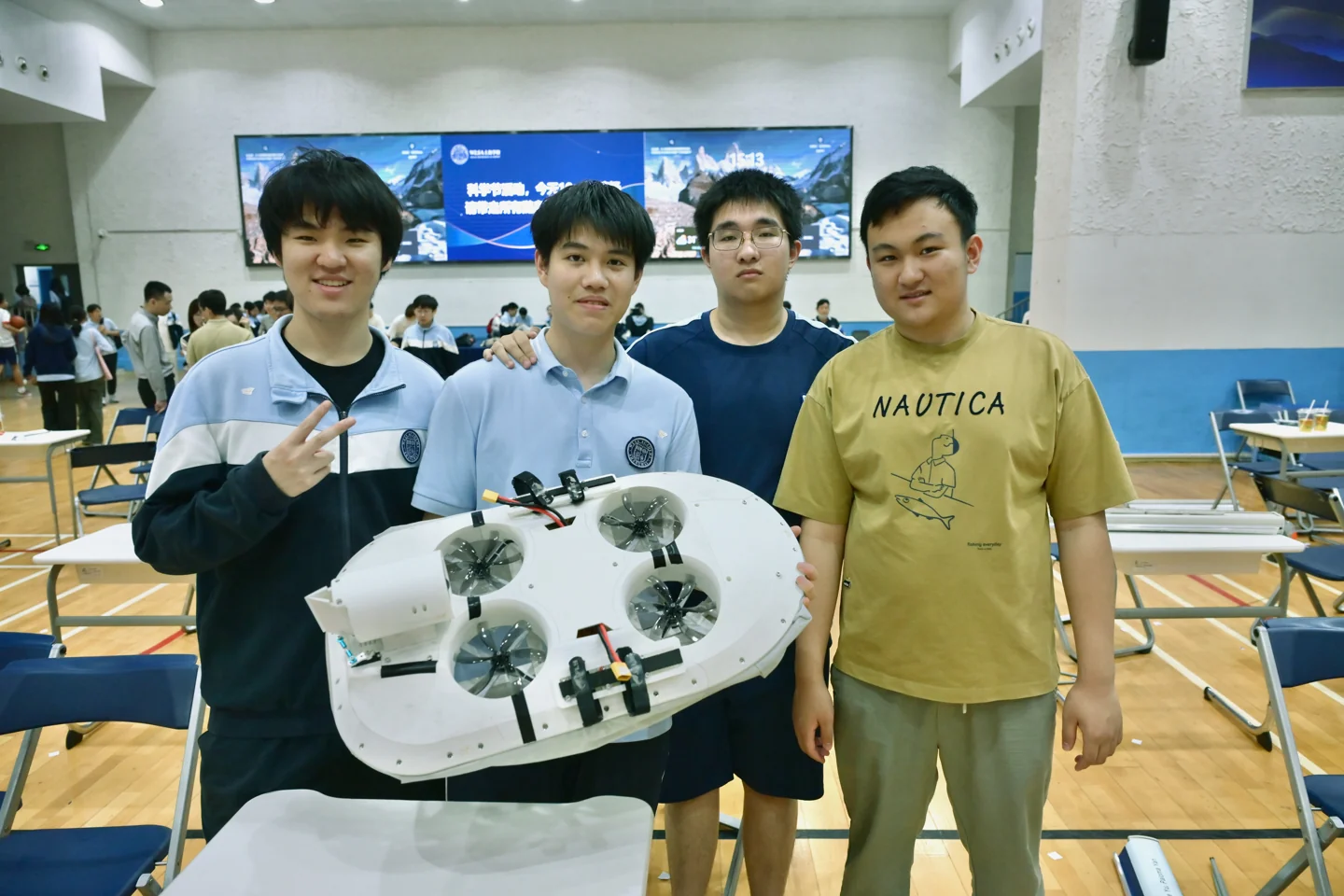 A group gathered around a robotics project