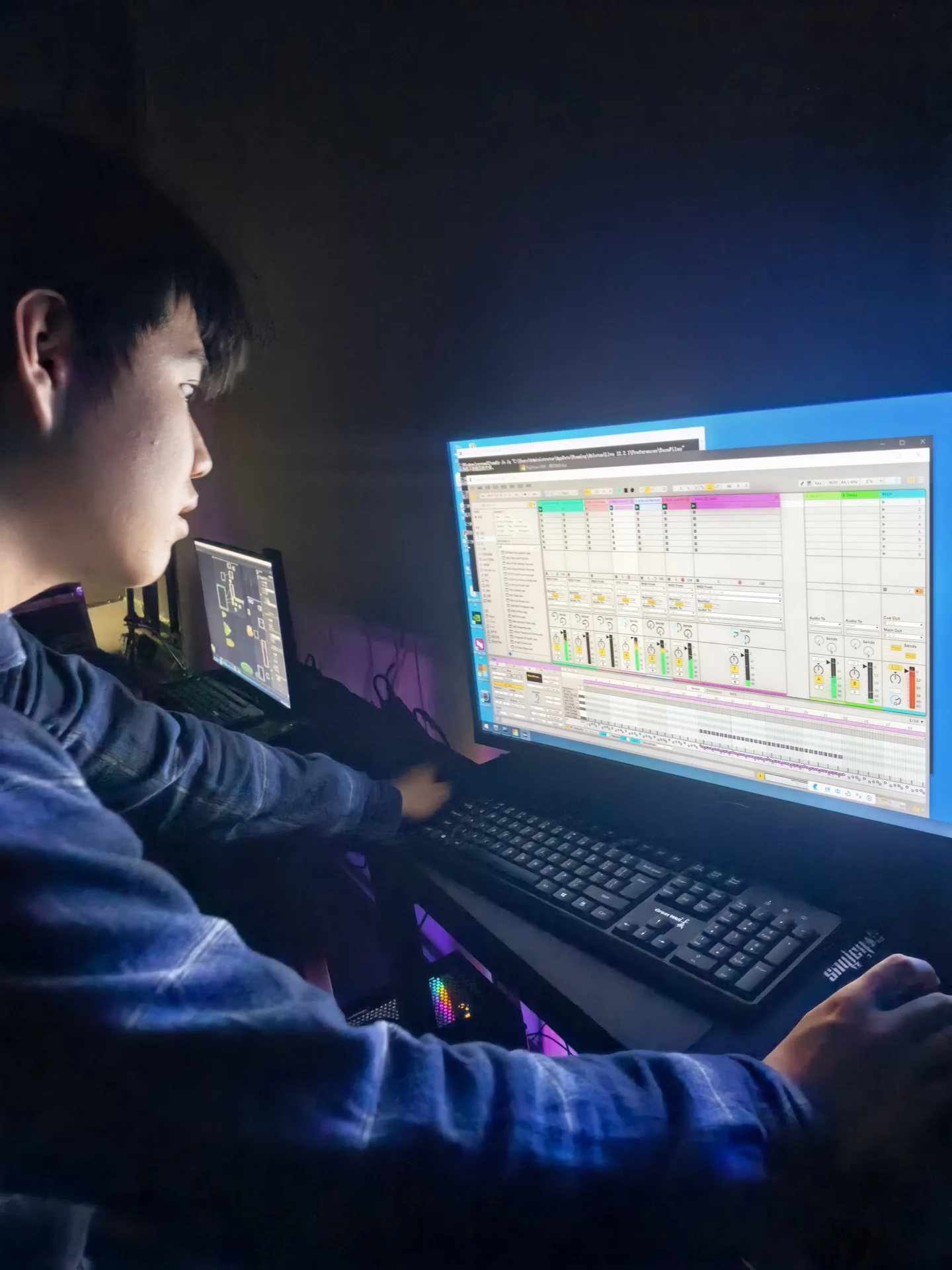Lala working on music at a computer in a recording space